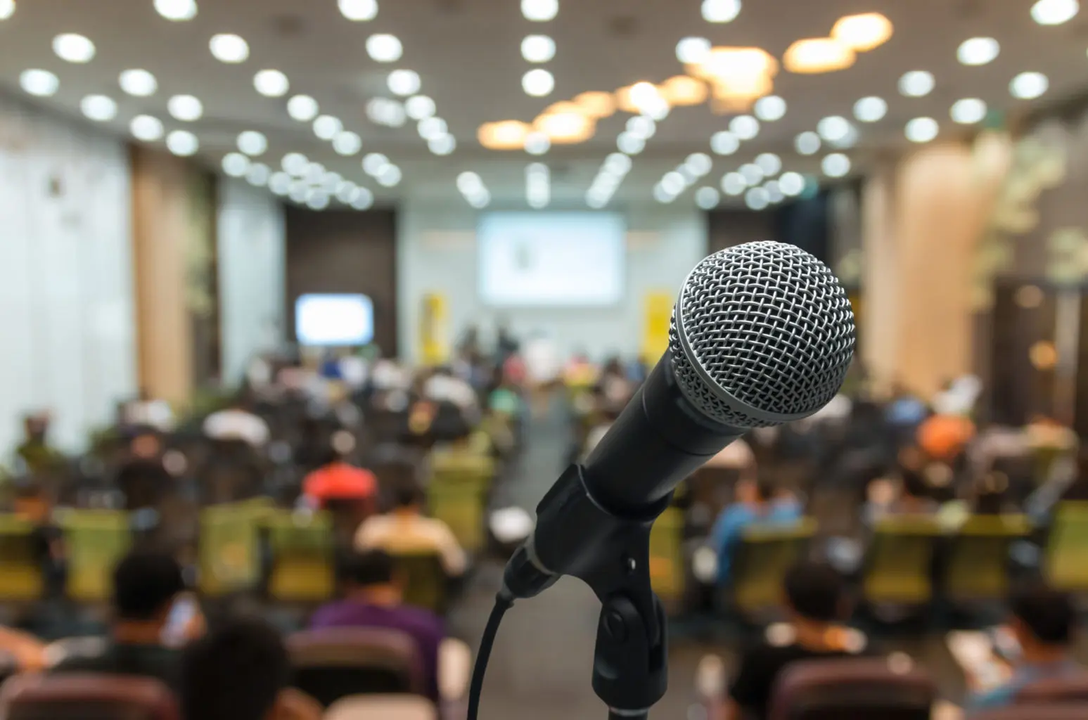 microphone-over-the-abstract-blurred-photo-of-conf-2024-02-23-05-04-35-utc-1547x1024