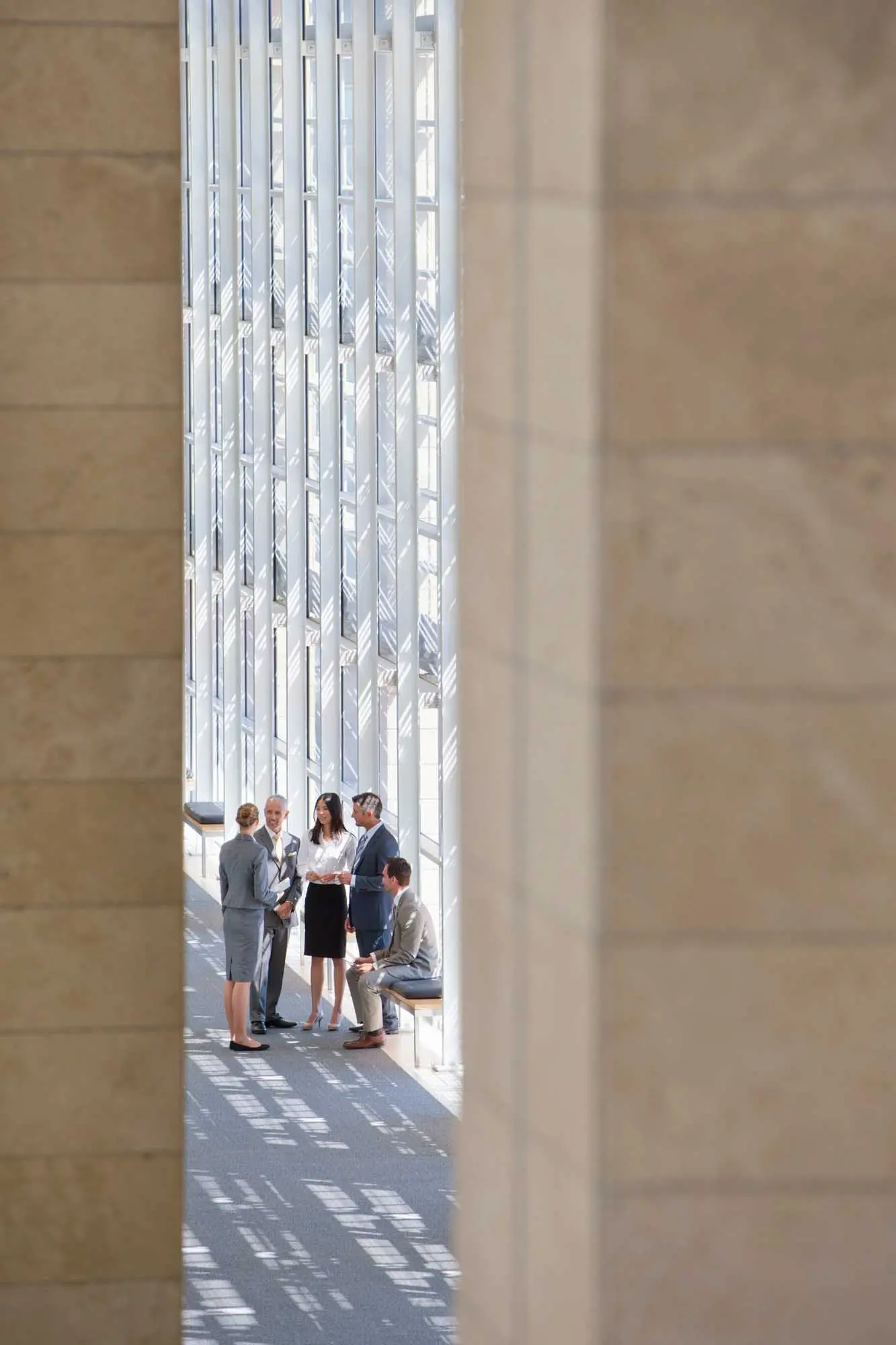 Business,Employees,Talking,In,The,Lobby,Of,A,Modern,Office